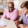 High School Tutor Giving Male Student One To One Tuition At Desk